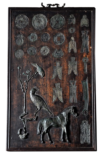 [CHINA - WOOD PANEL WITH ANCIENT COINS AND CHARMS]. - China, probably end of 18th century.